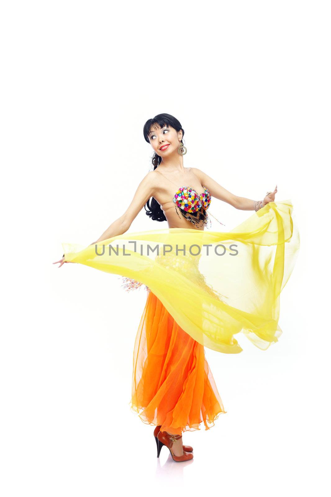 Beautiful lady dancing belly dance with yellow fabric