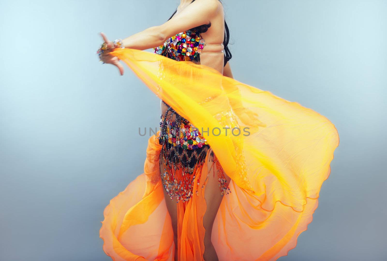 Dancing belly dancer moving her traditional dress