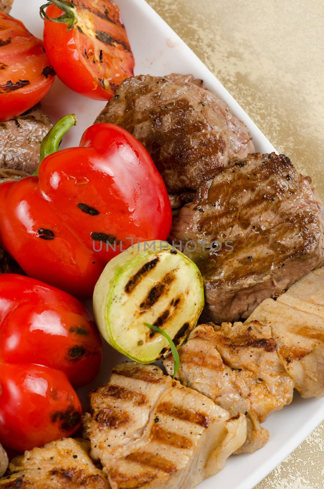 BBQ meat with vegetables and greens closeup
