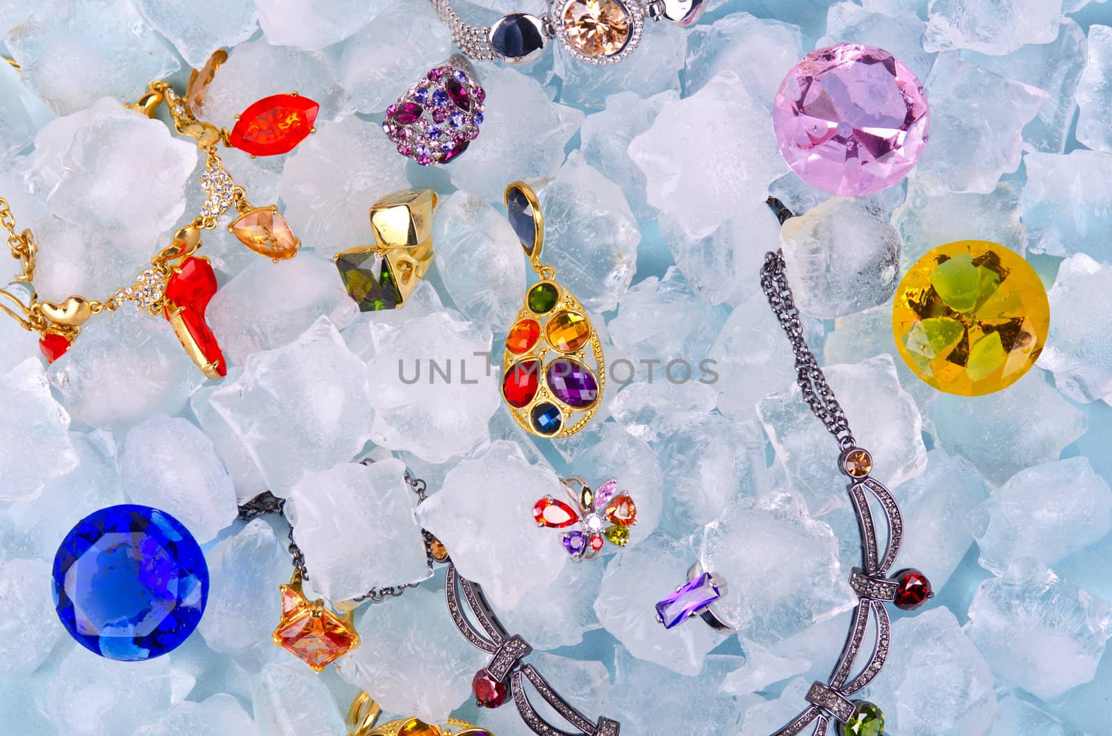 Jewels at blue cube of ice background