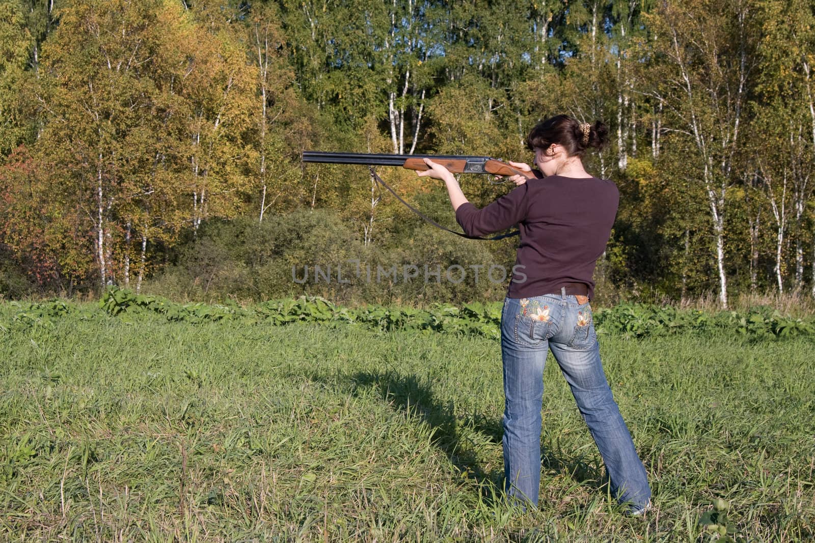 The girl aims from a gun at a targetnd