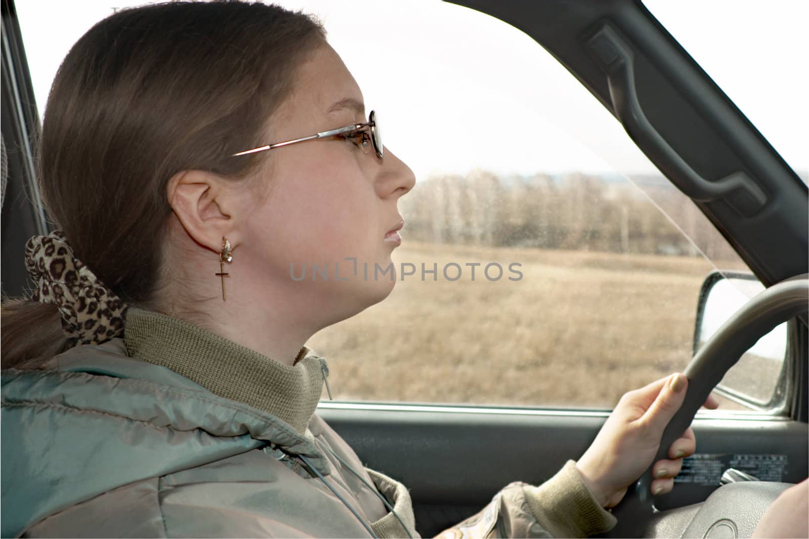 The young girl is trained to operate the automobile