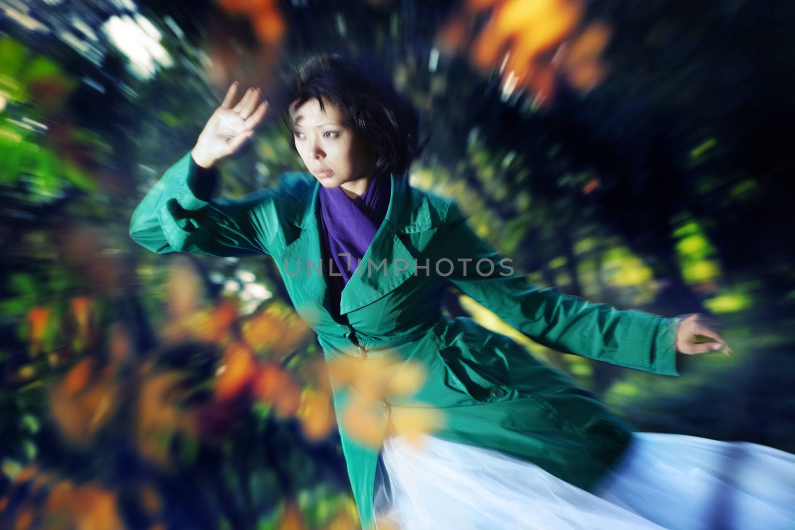Lady outdoors in autumn. Photo with zoom-in blur effect