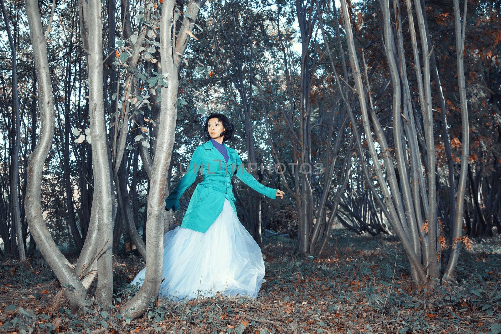 Brunette lady walking in the autumn forest