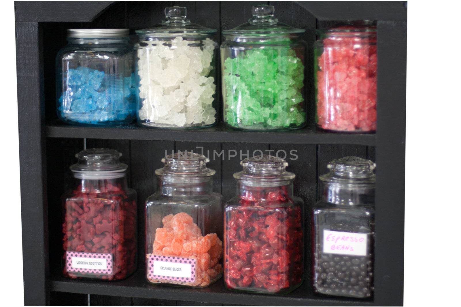 Candy in container on store shelf by GunterNezhoda