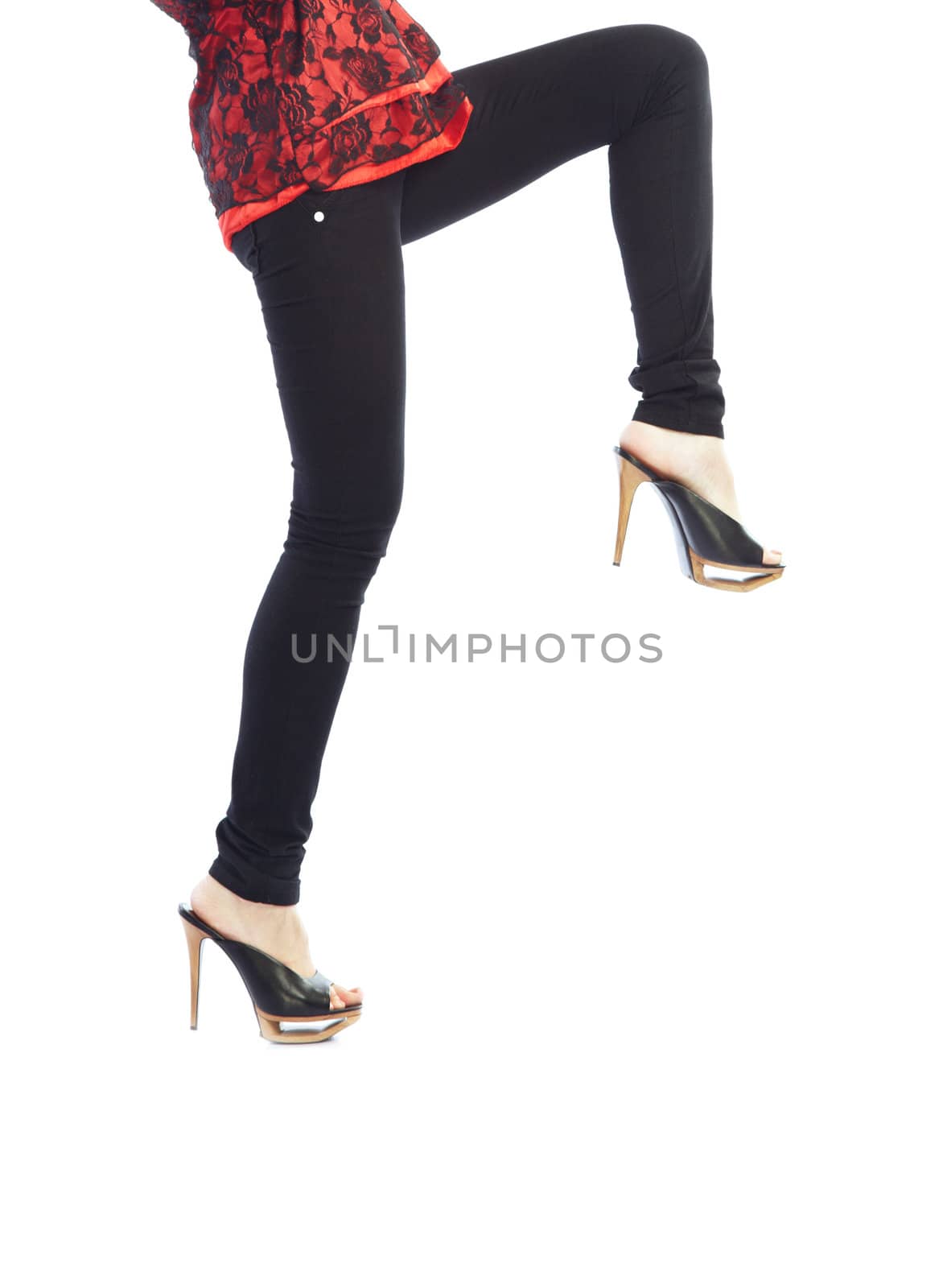 Close-up photo of woman legs in black trousers going on a white background