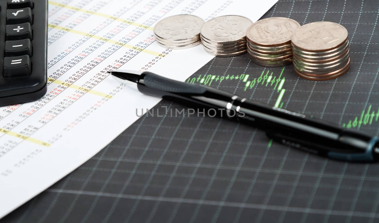 Coins and pen lying on sheet of paper with data