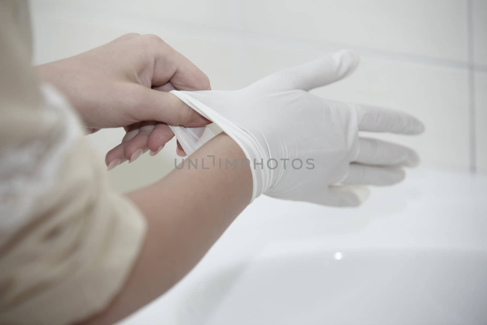 Hands of human taking on rubber gloves