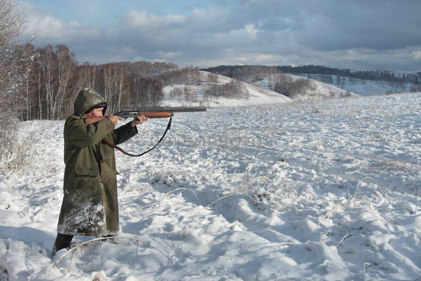 The hunter in the winter on a marge of a wood