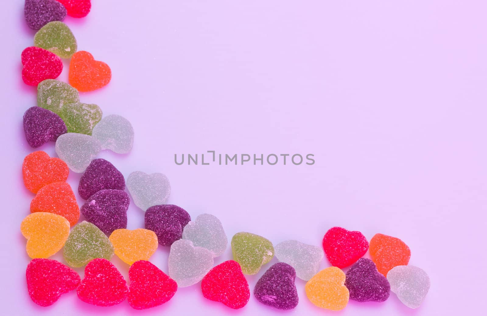 Love-shaped jelly on white background under purple gel illumination for background use
