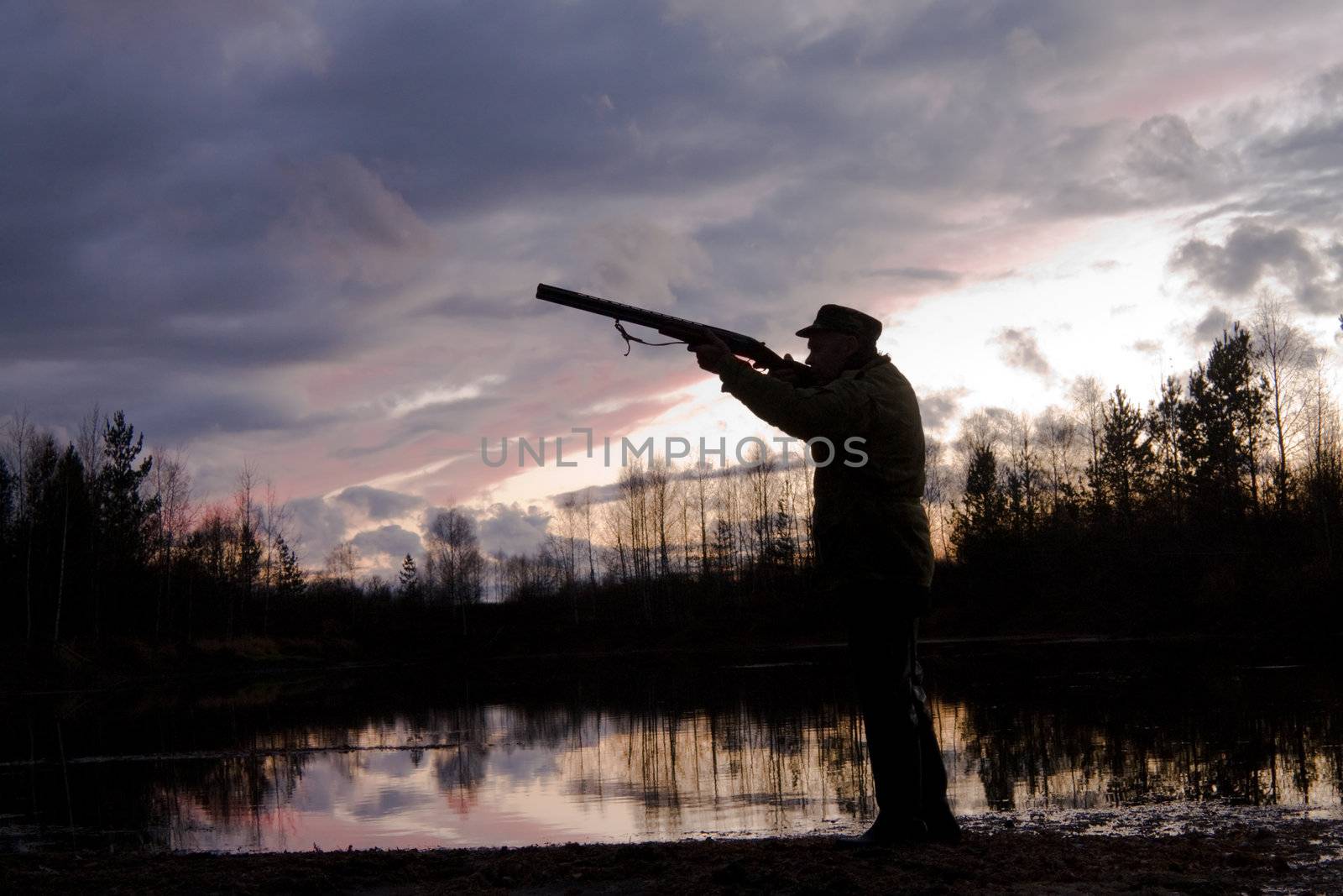 Silhouette of the hunter on a background of a morning dawn