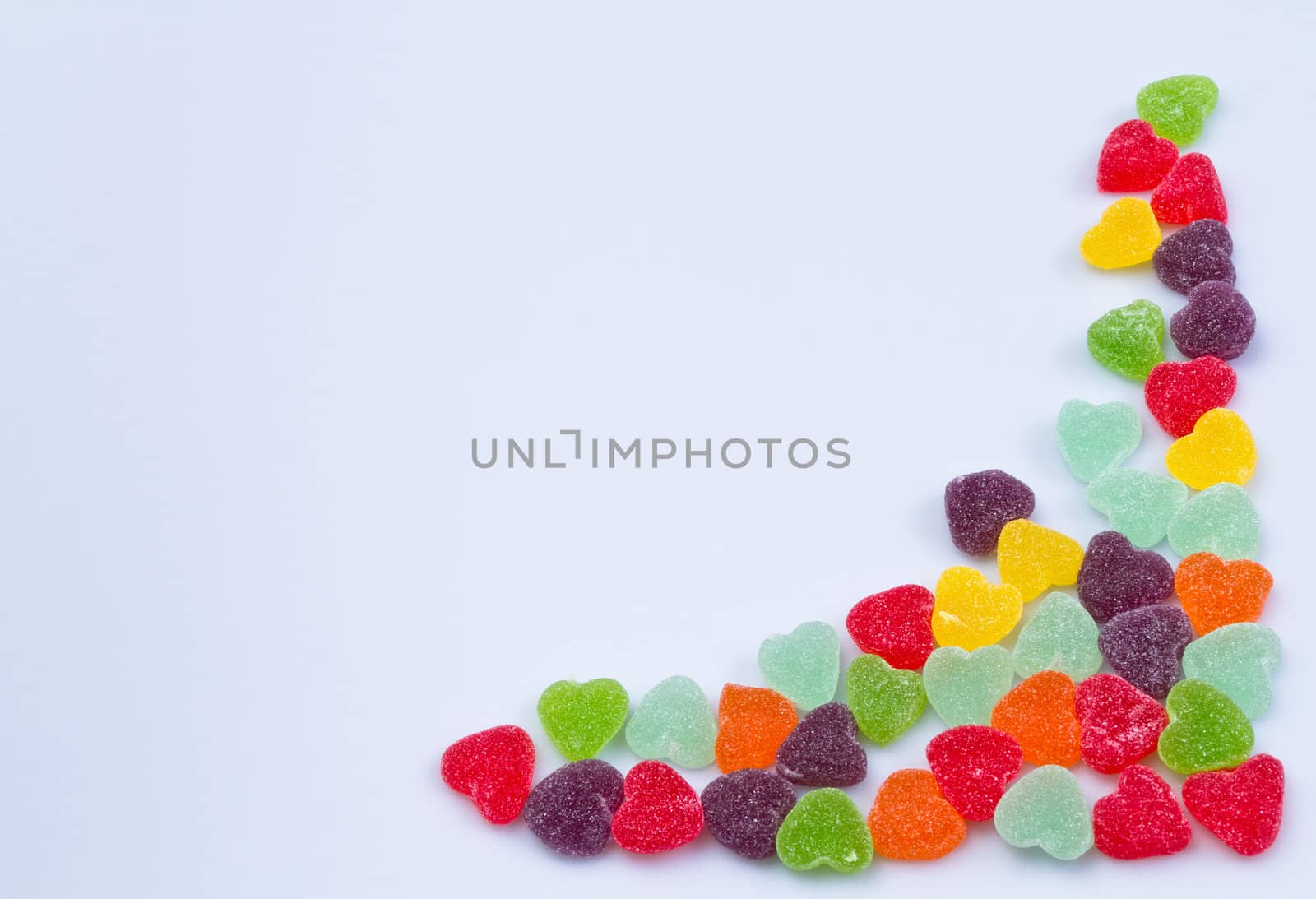 Love-shaped jelly on white surface for background use