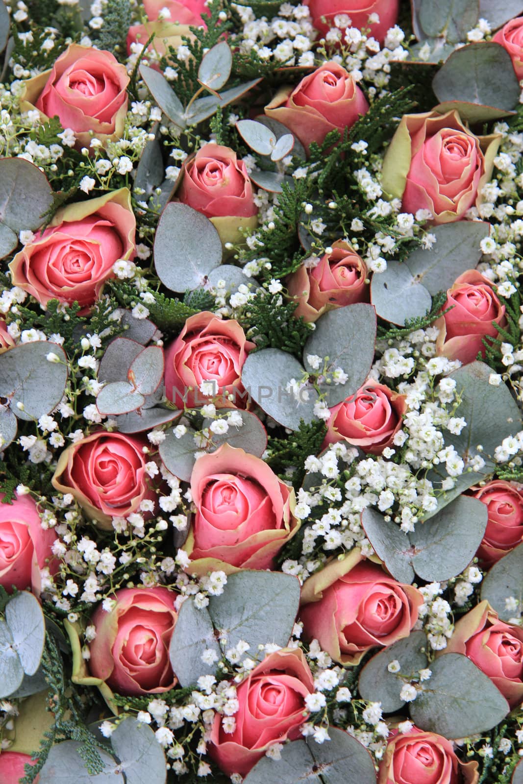 Floral arrangement with pink roses, gypsophila and eucalyptus