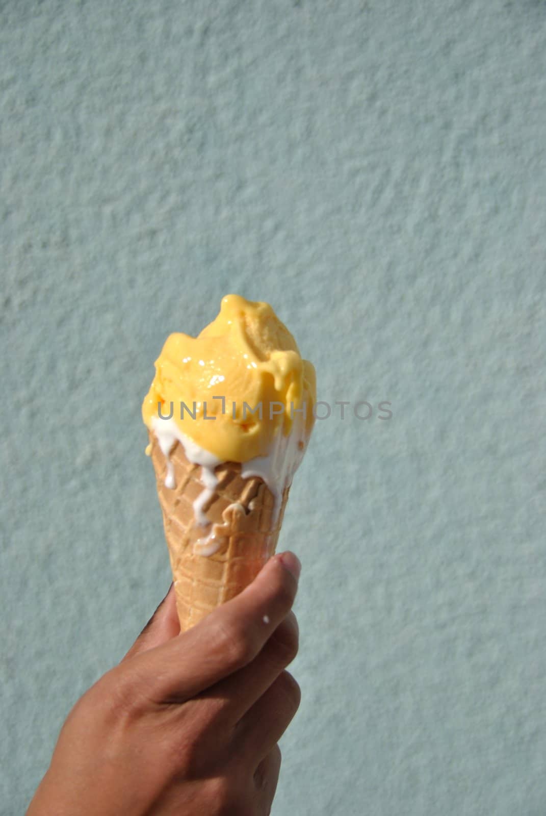 icecream melting down in a lass  hand