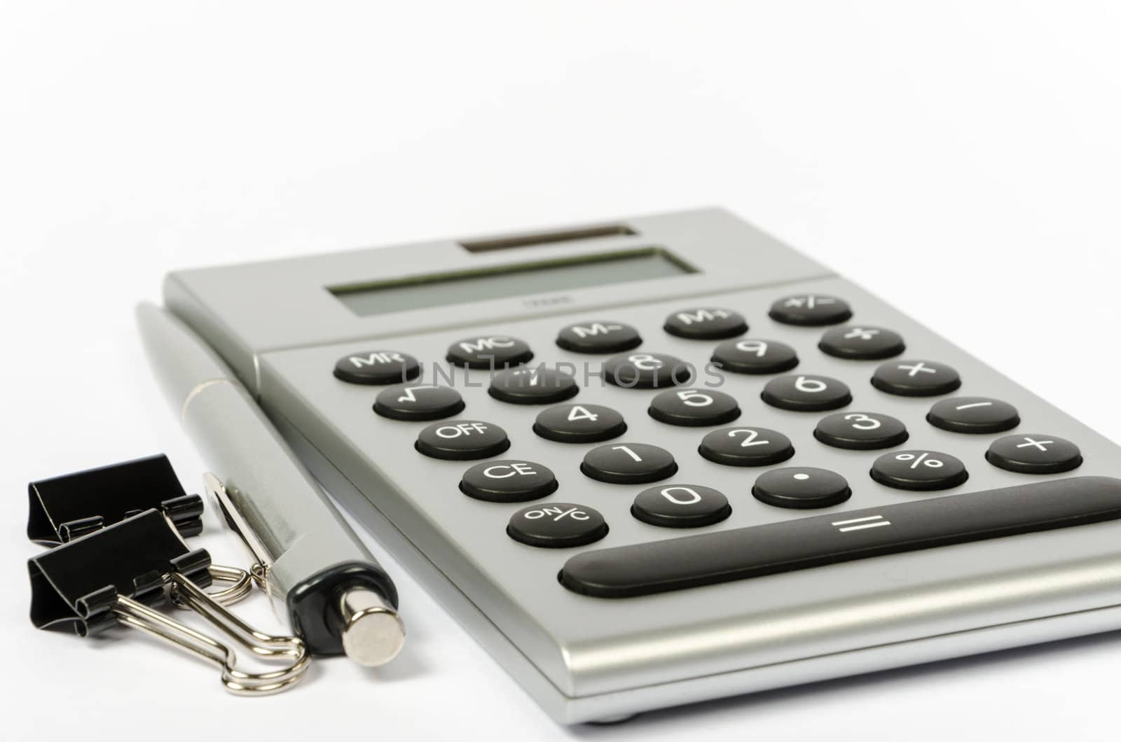A calculator and a pen on a white background by velislava