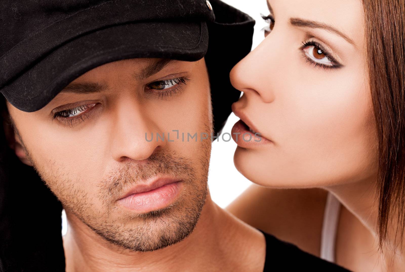 Close-up of beautiful female whispering to a man's ear