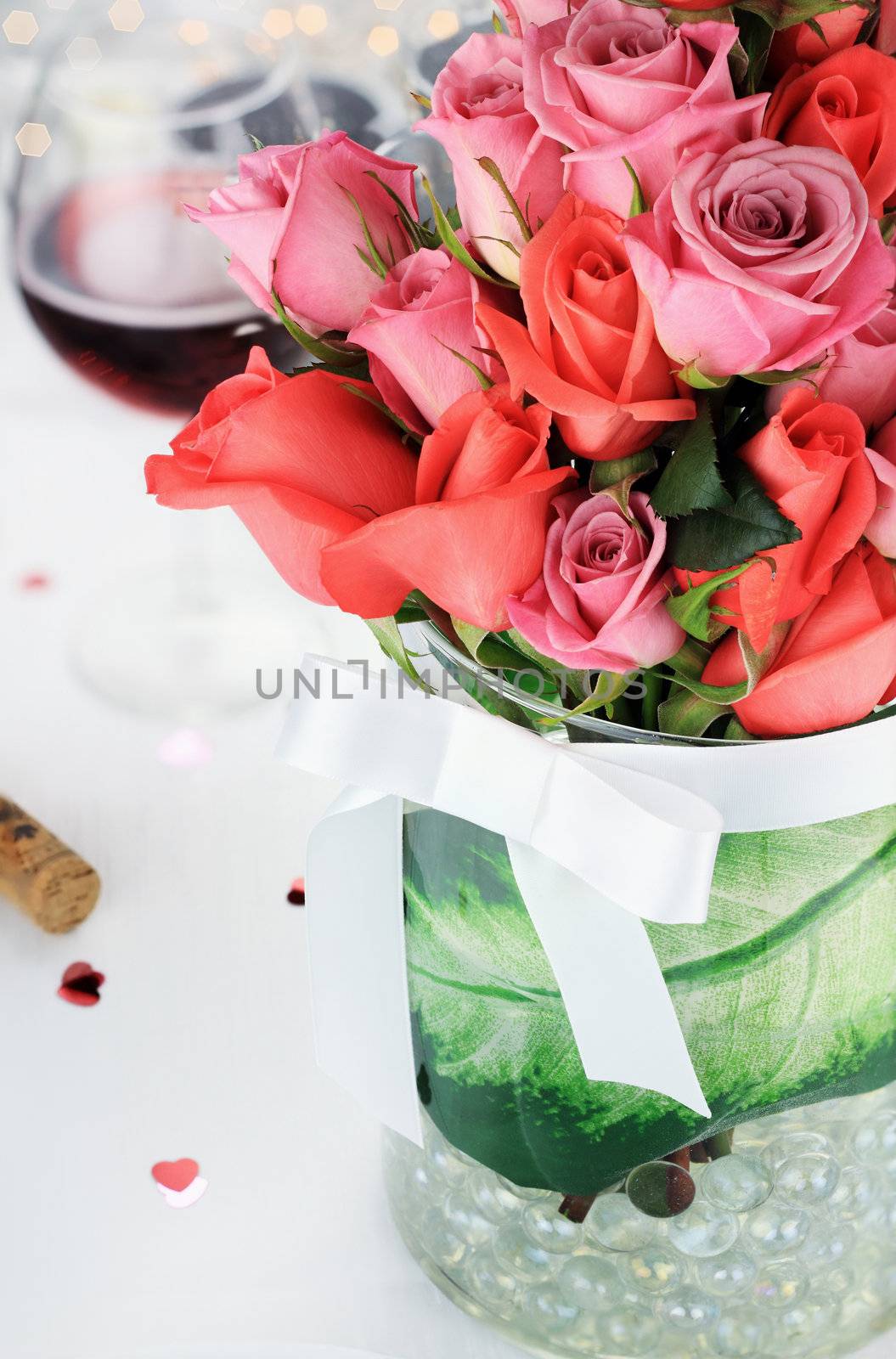 Bouquet of roses against a romantic table setting. Selective focus on roses blossoms with blur on lower portion of image.