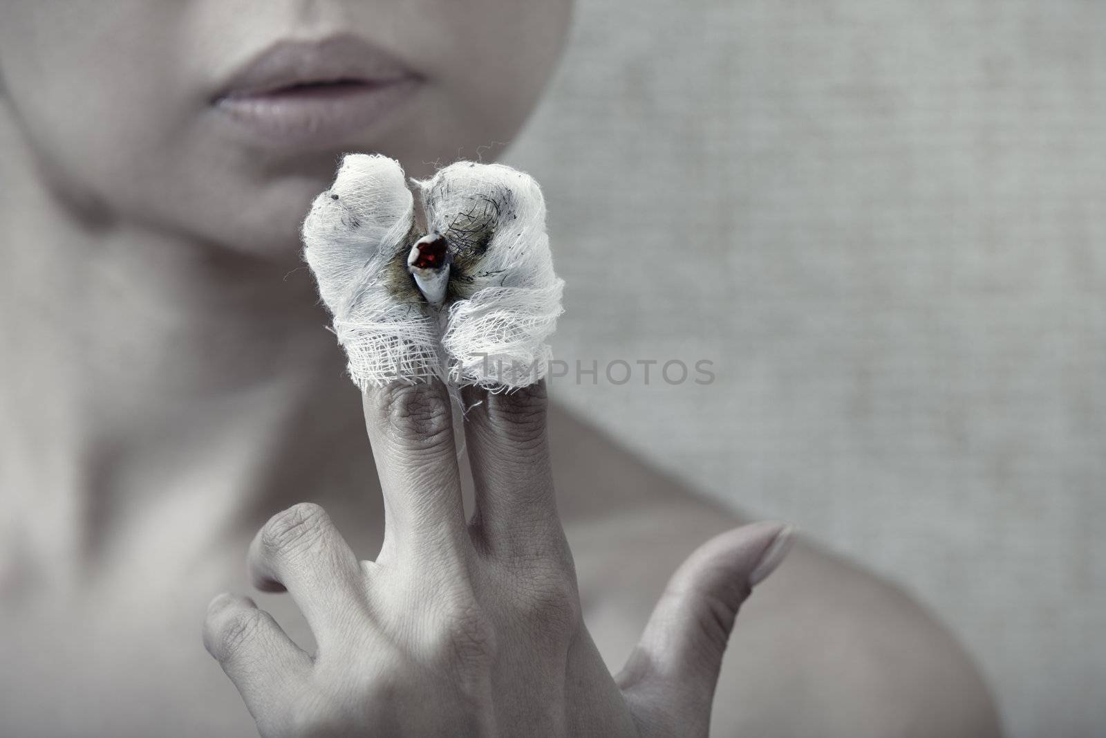 Woman with burnt fingers smoking cigarette stub