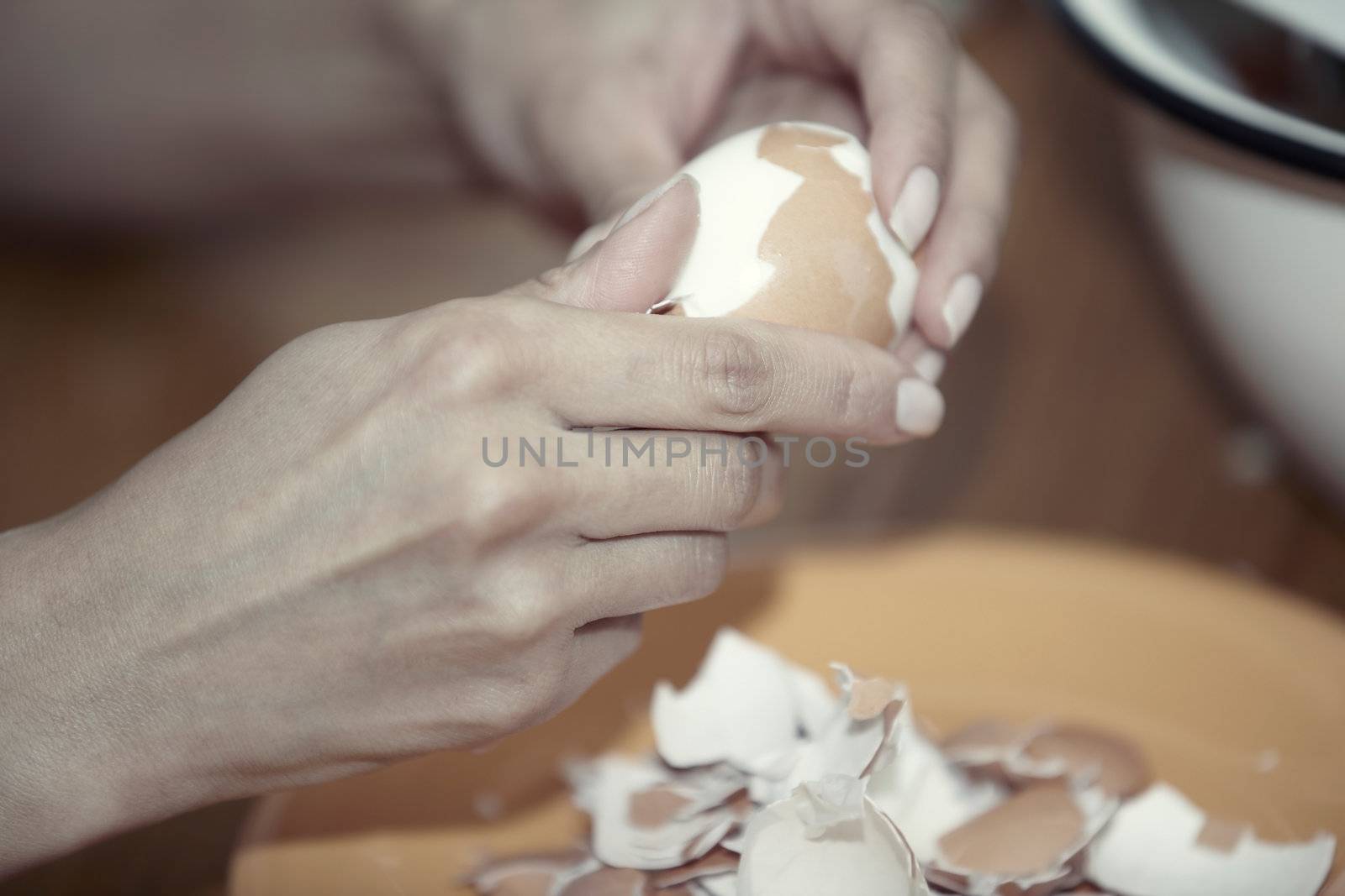 Human hand clearing boiled egg