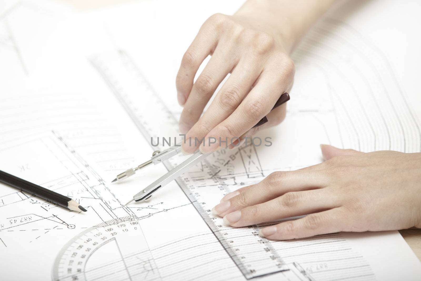 Hands of engineer working on a construction plan