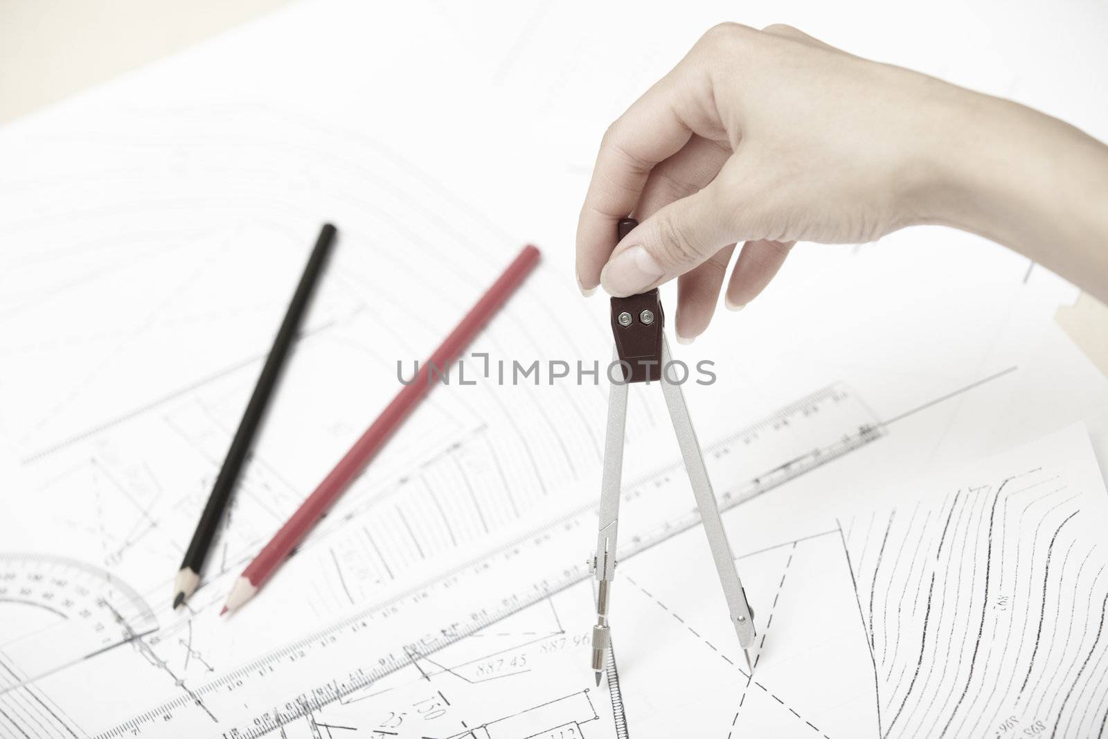 Hand of engineer working on a construction plan