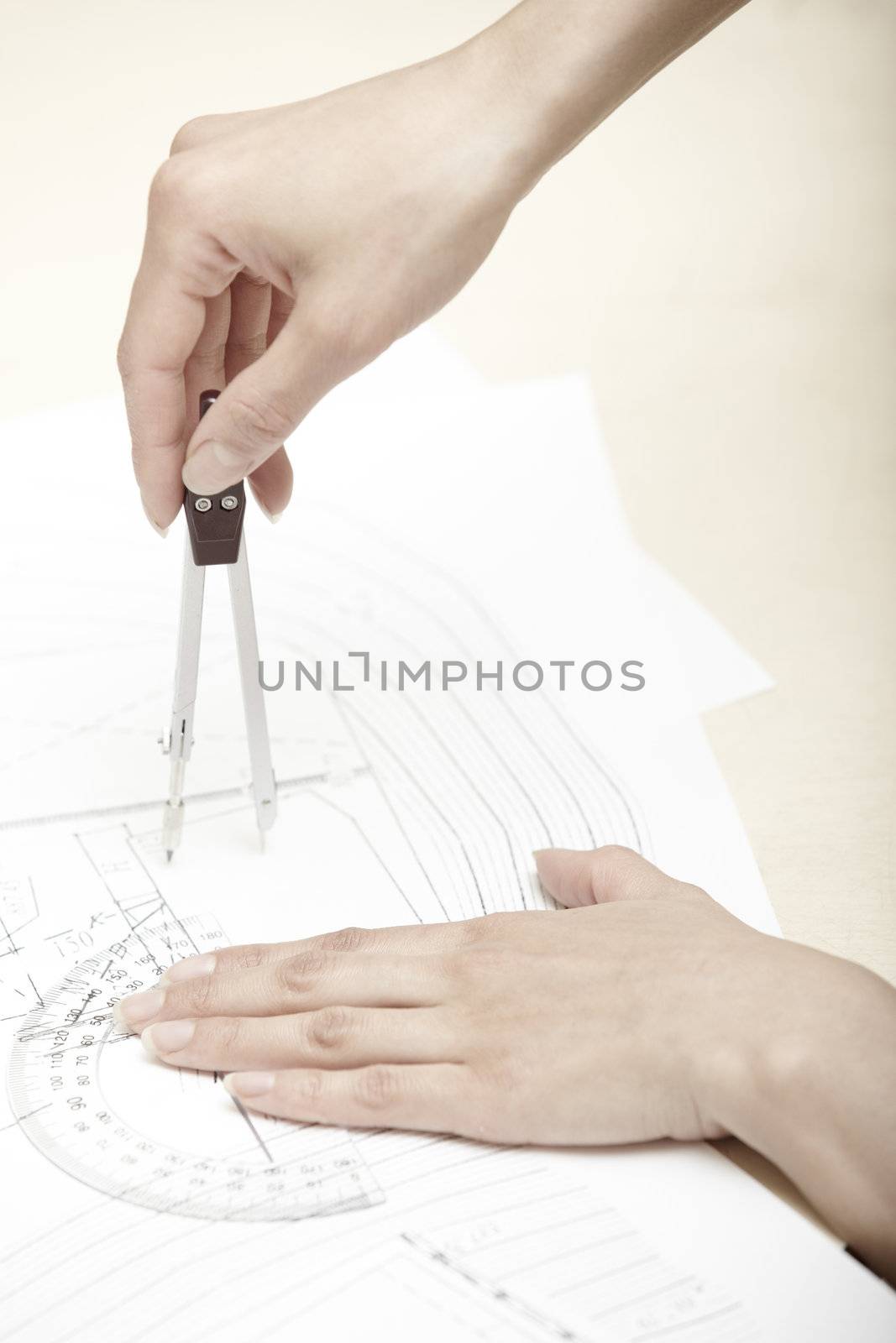 Hands of engineer working on a construction plan