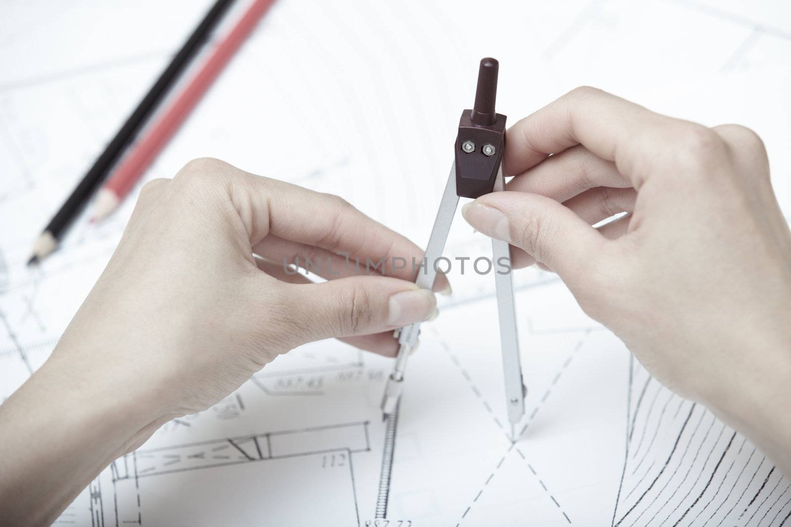 Hands of engineer working on a construction plan