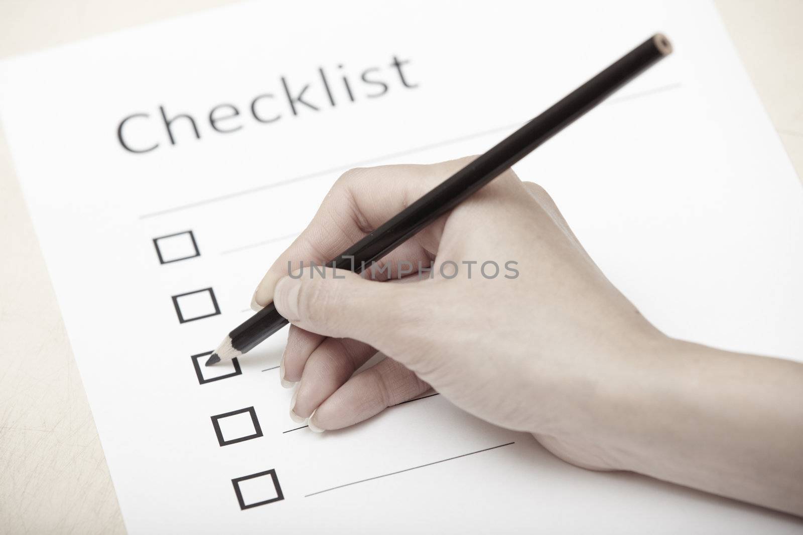 Human hand writing on a checklist document