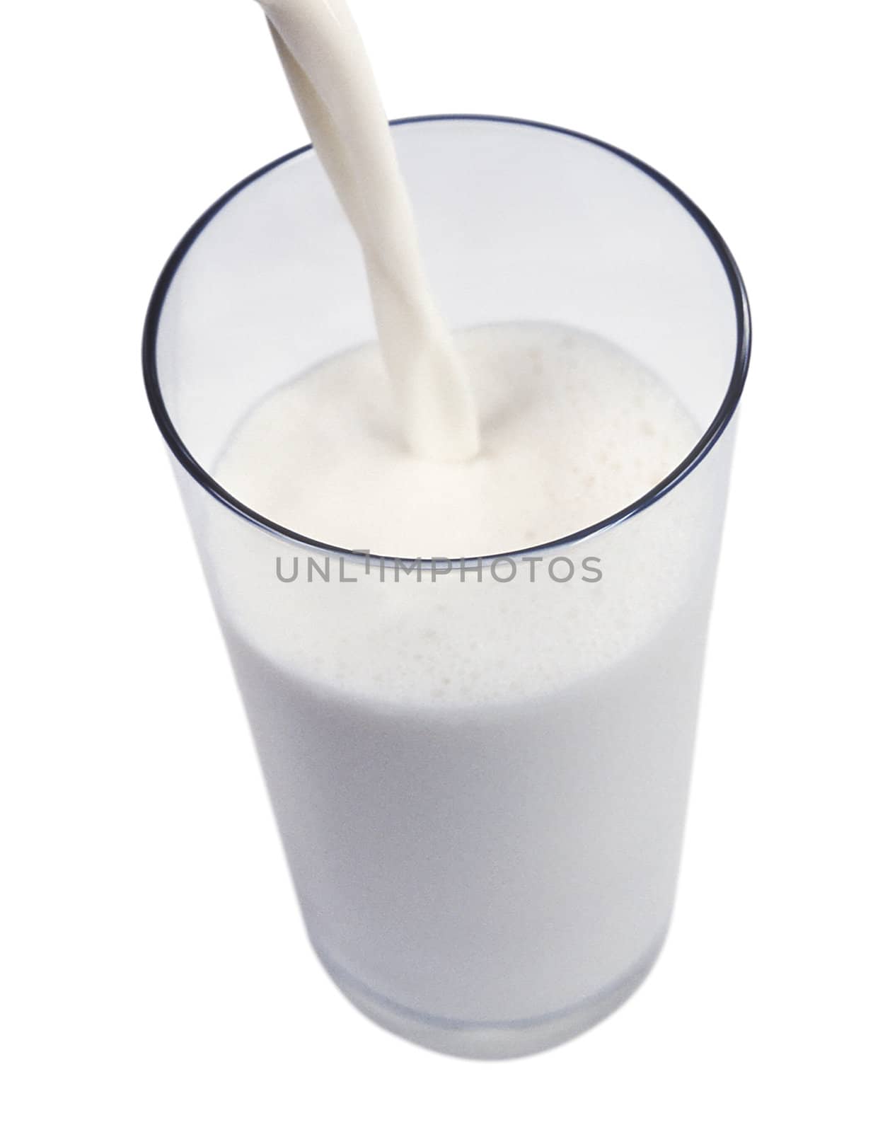 pouring milk in a glass isolated