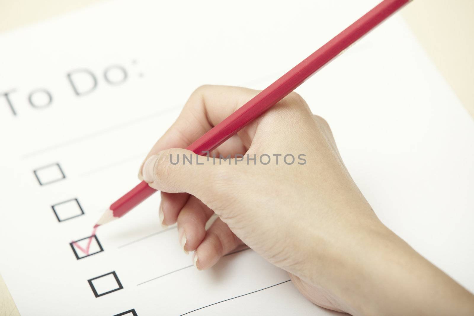 Human hand writing on a checklist document