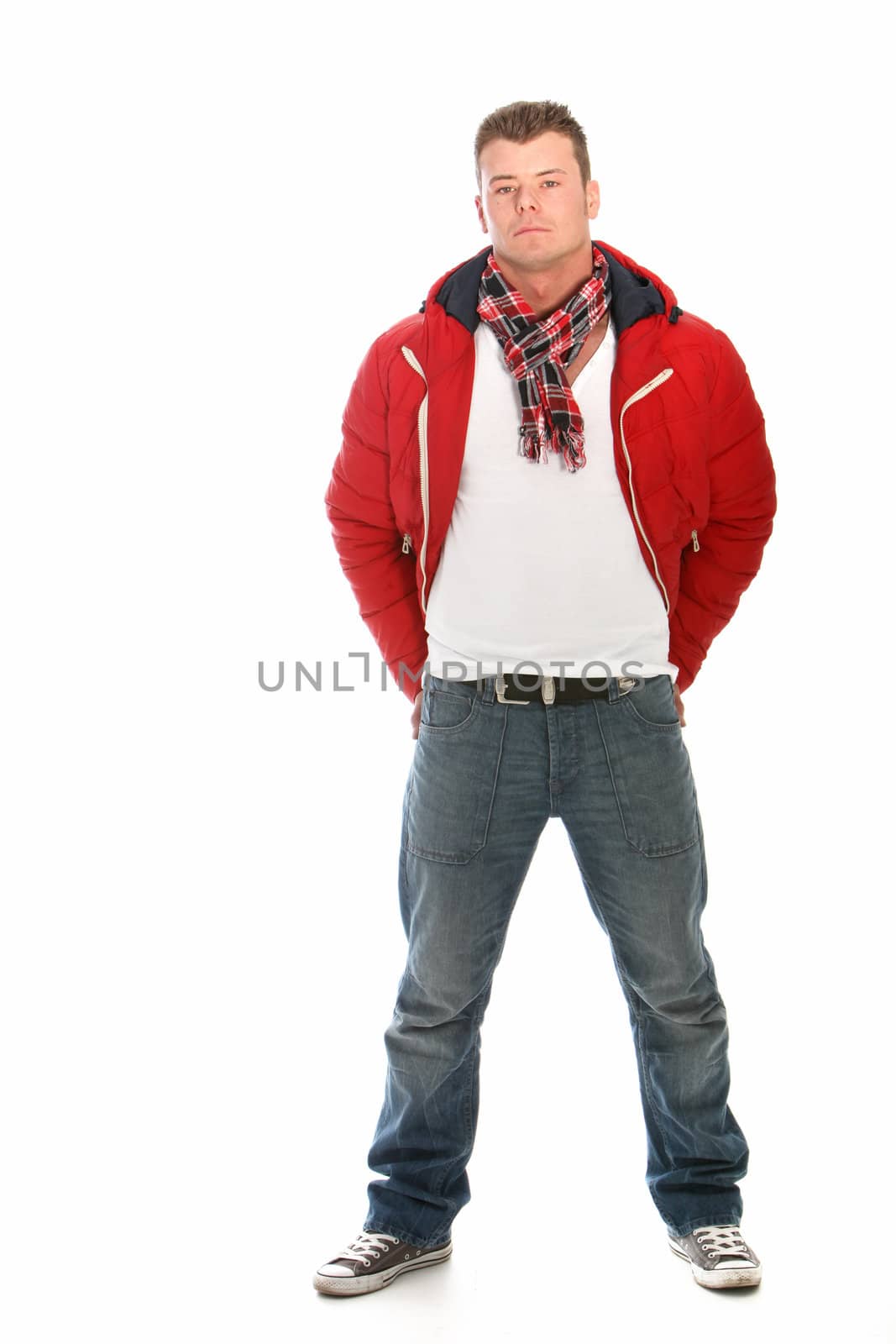 Casual man wearing red jacket and jeans standing on a white background