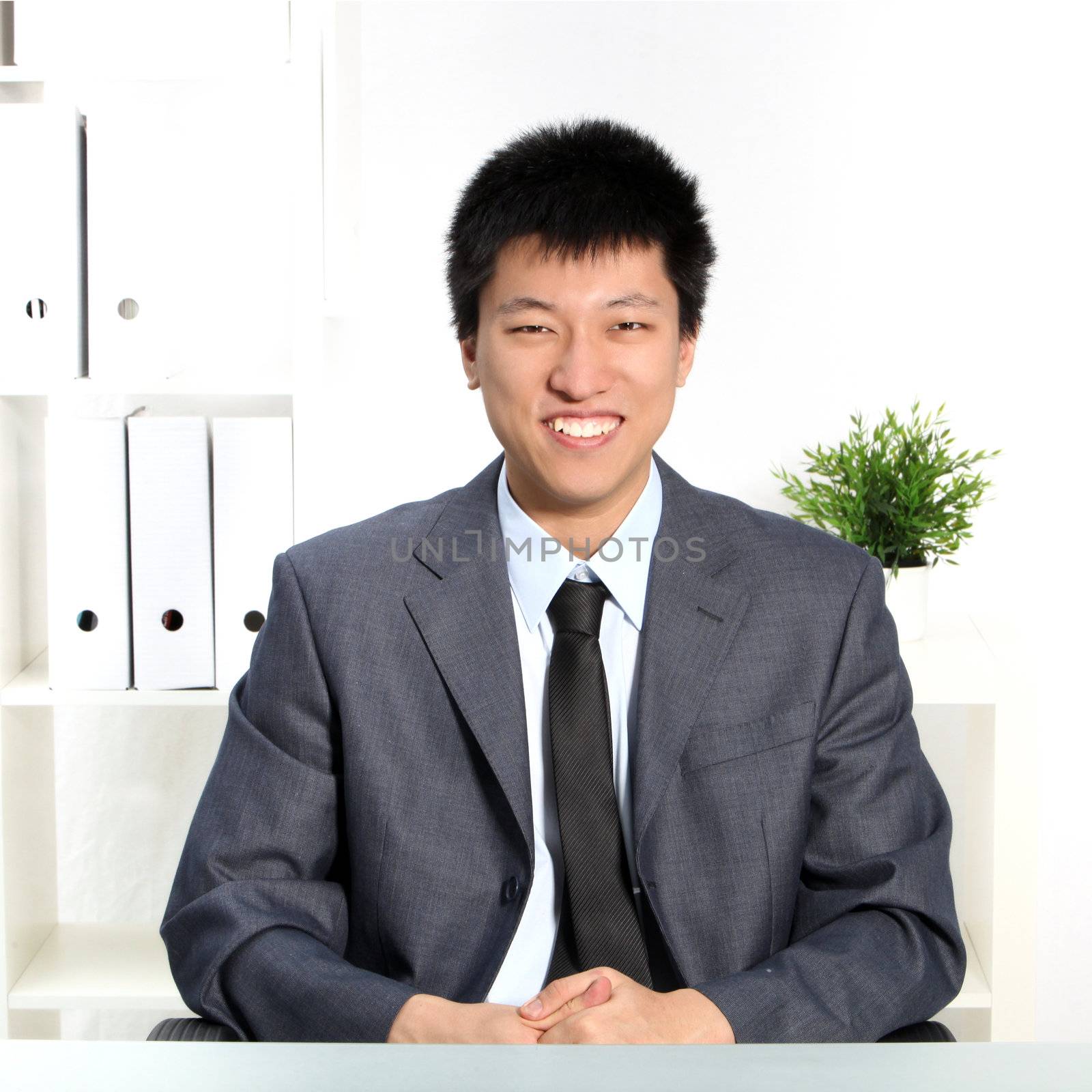 Confident happy young Asian businessman by Farina6000