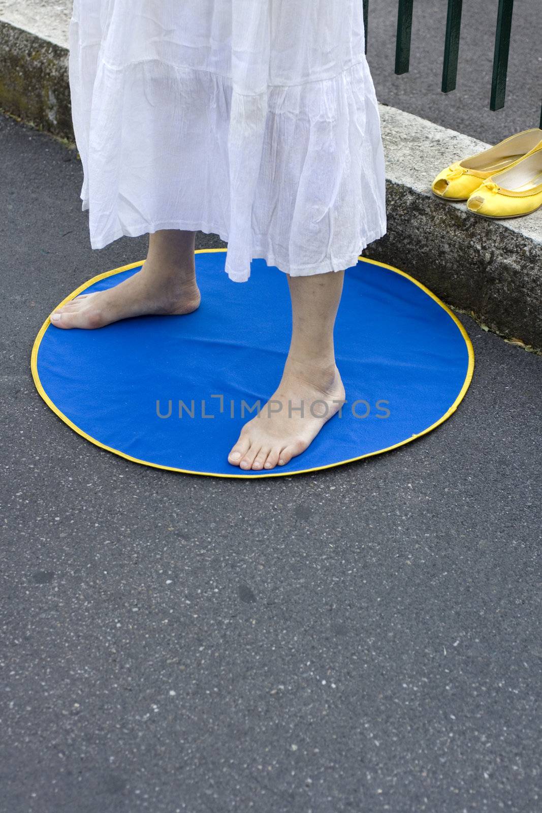 Feet of a woman meditating on a blue mat