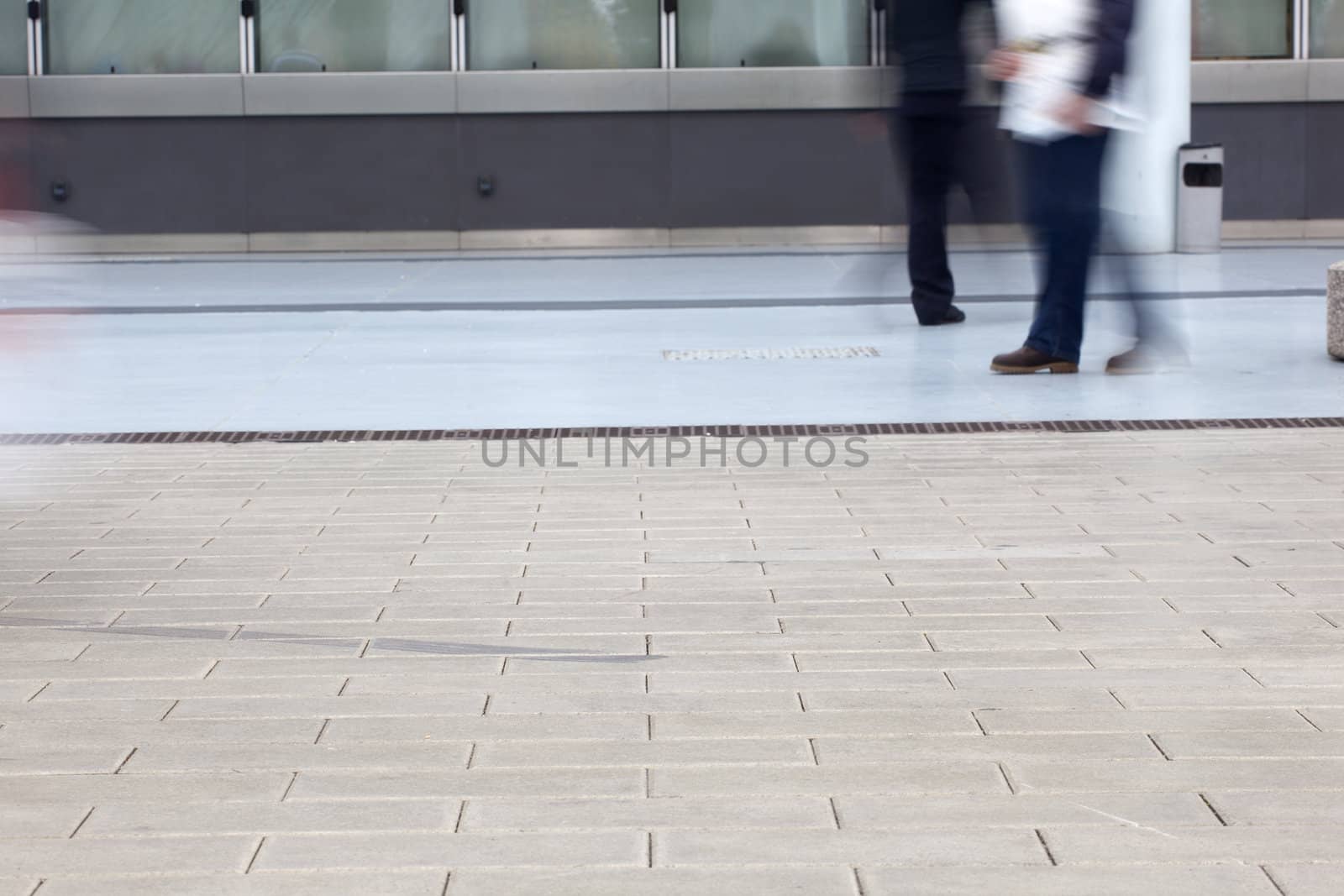 Photo of the feet that walk on the sidewalk
