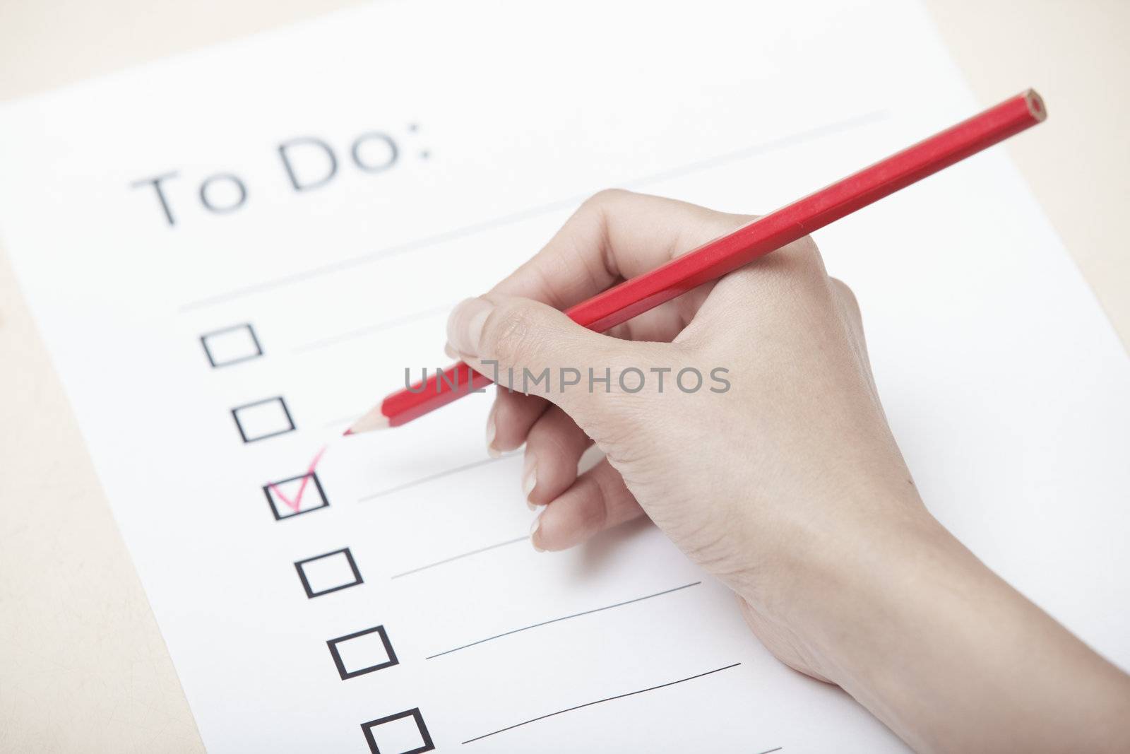 Human hand writing on a checklist document