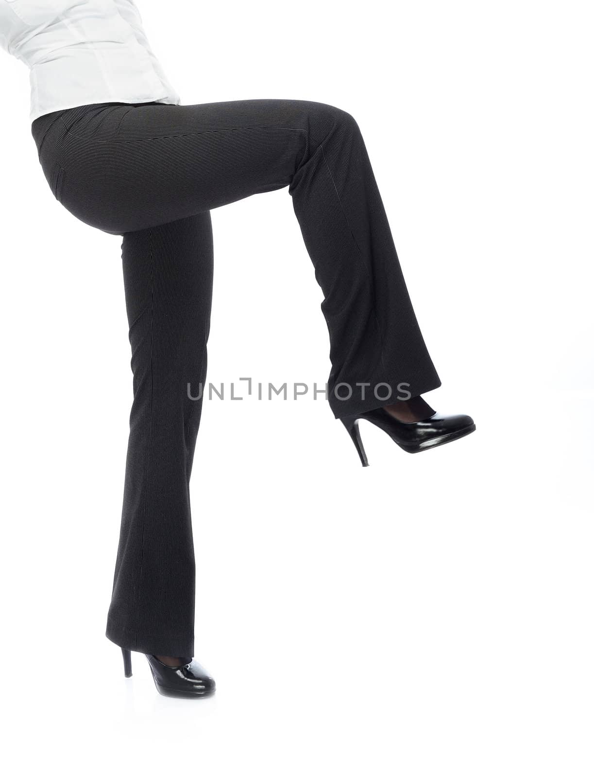 Close-up photo of businesswoman legs in black trousers going on a white background