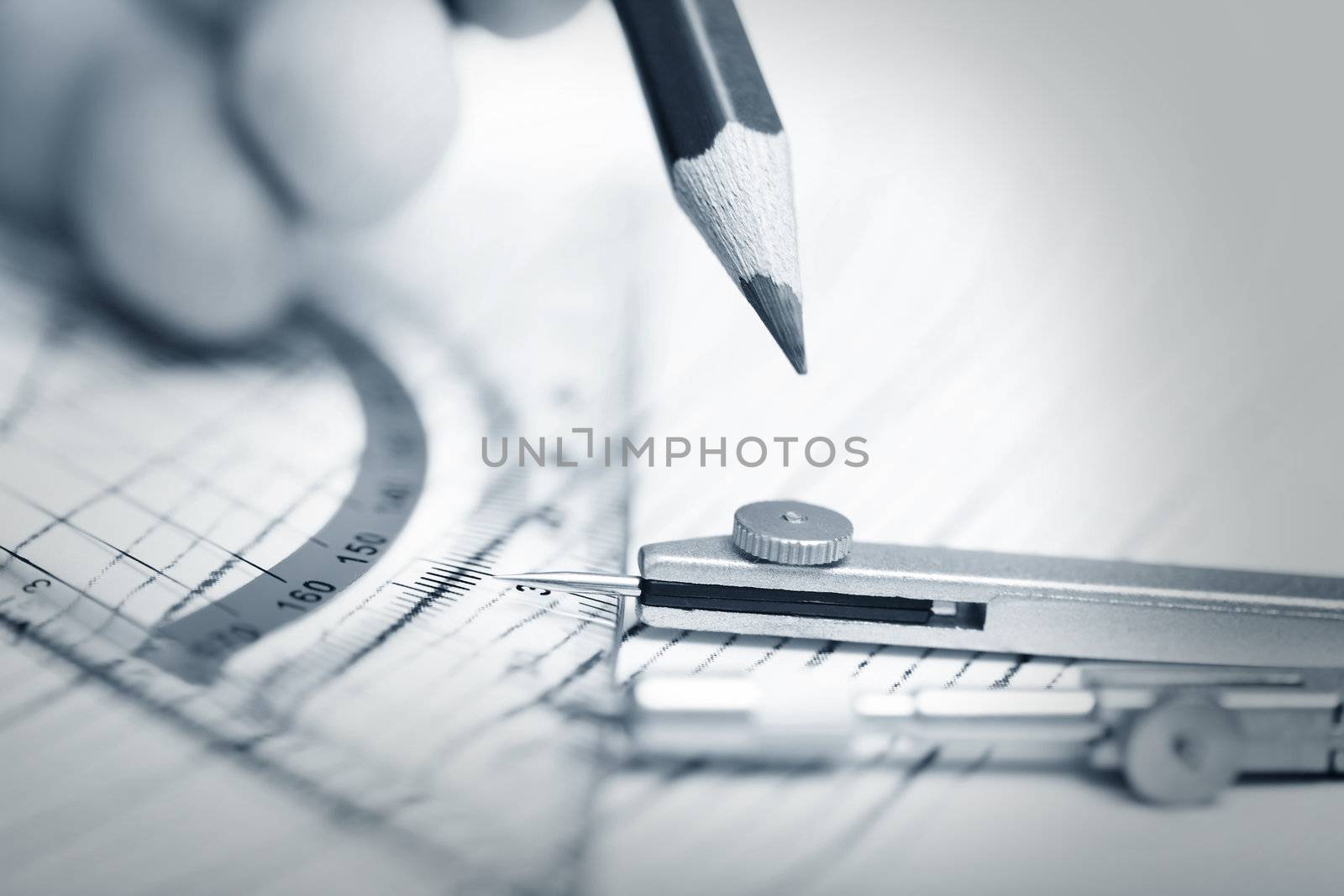 Human hand drawing engineering scheme with red pencil. Close-up photo