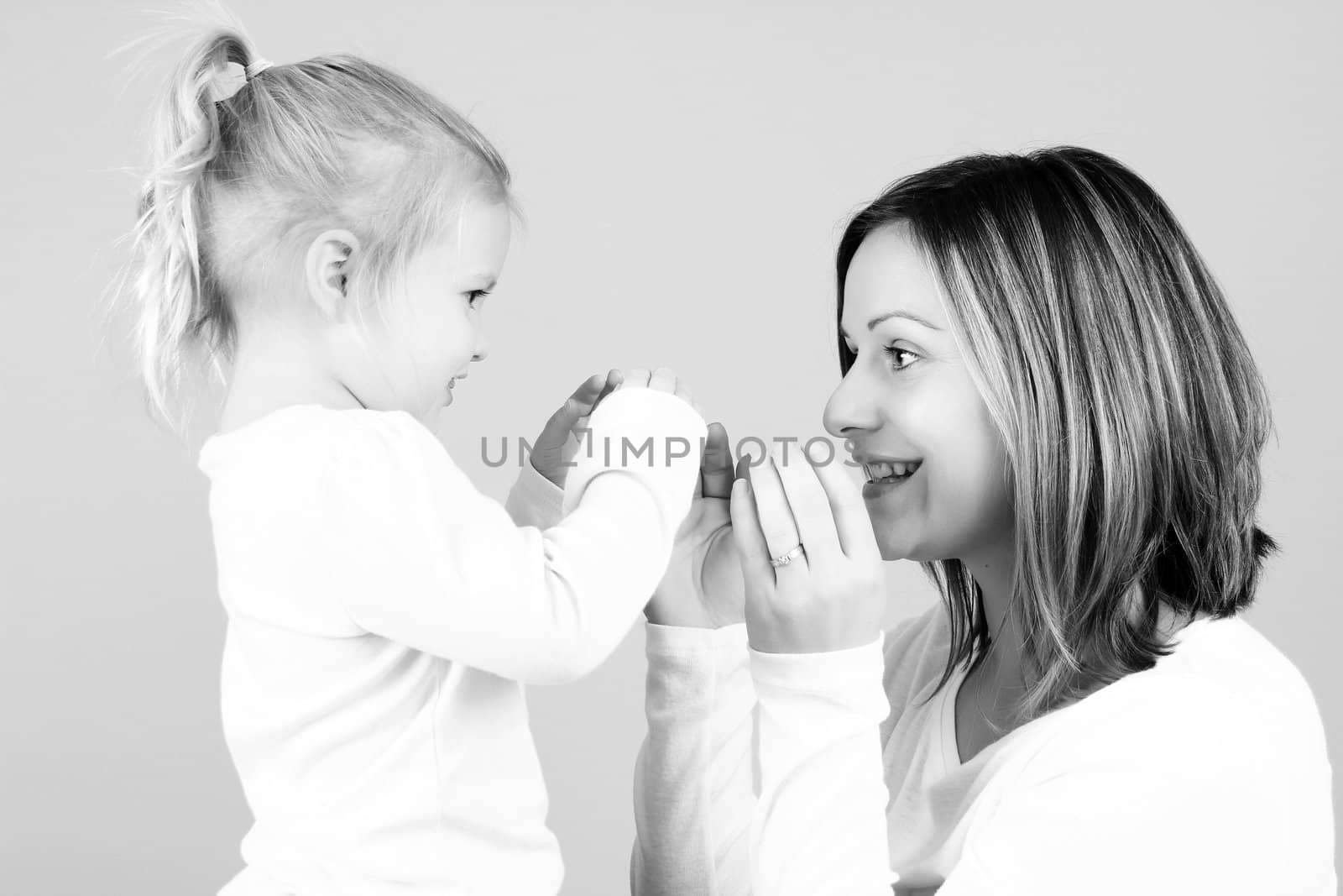 Beautiful mother and toddler daughter playing together