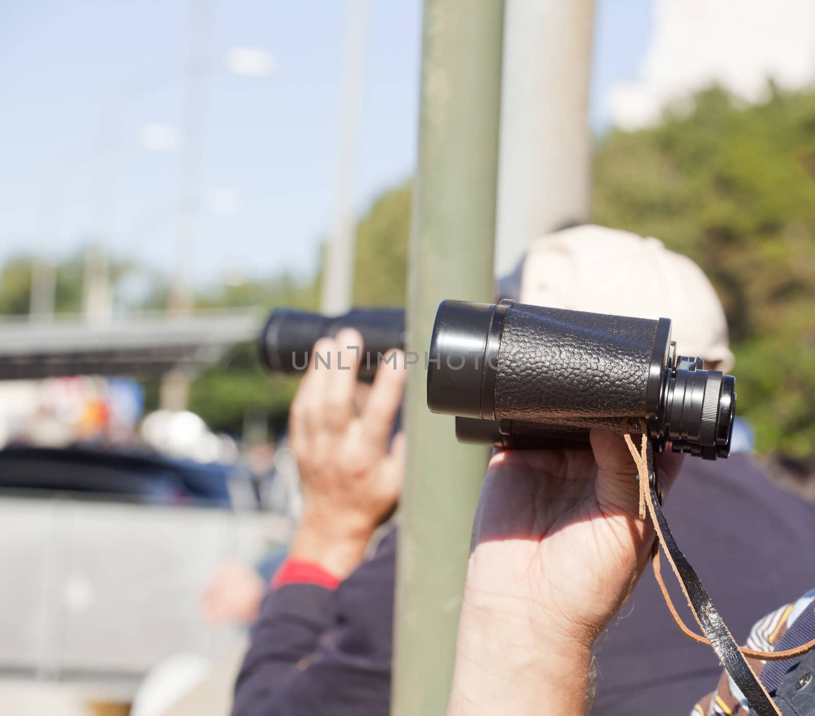 A man looking with binocular