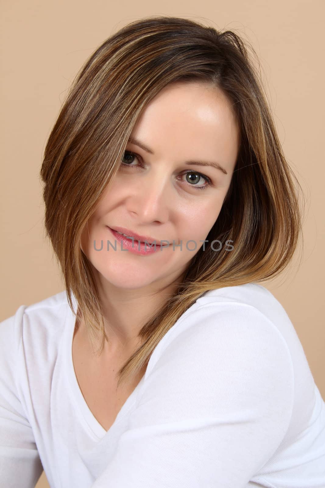 Beautiful adult brunette female against brown background