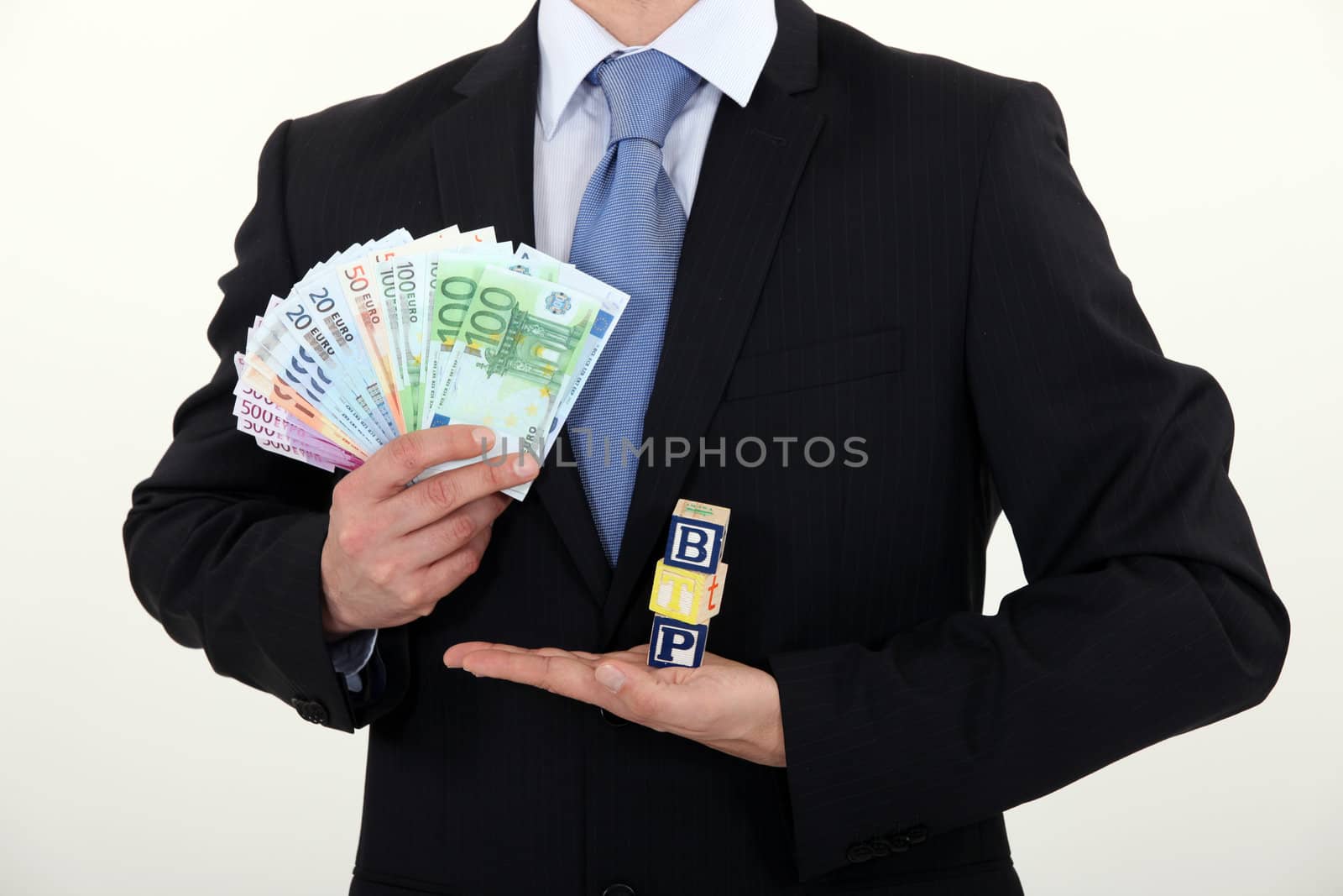 Businessman holding cash by phovoir