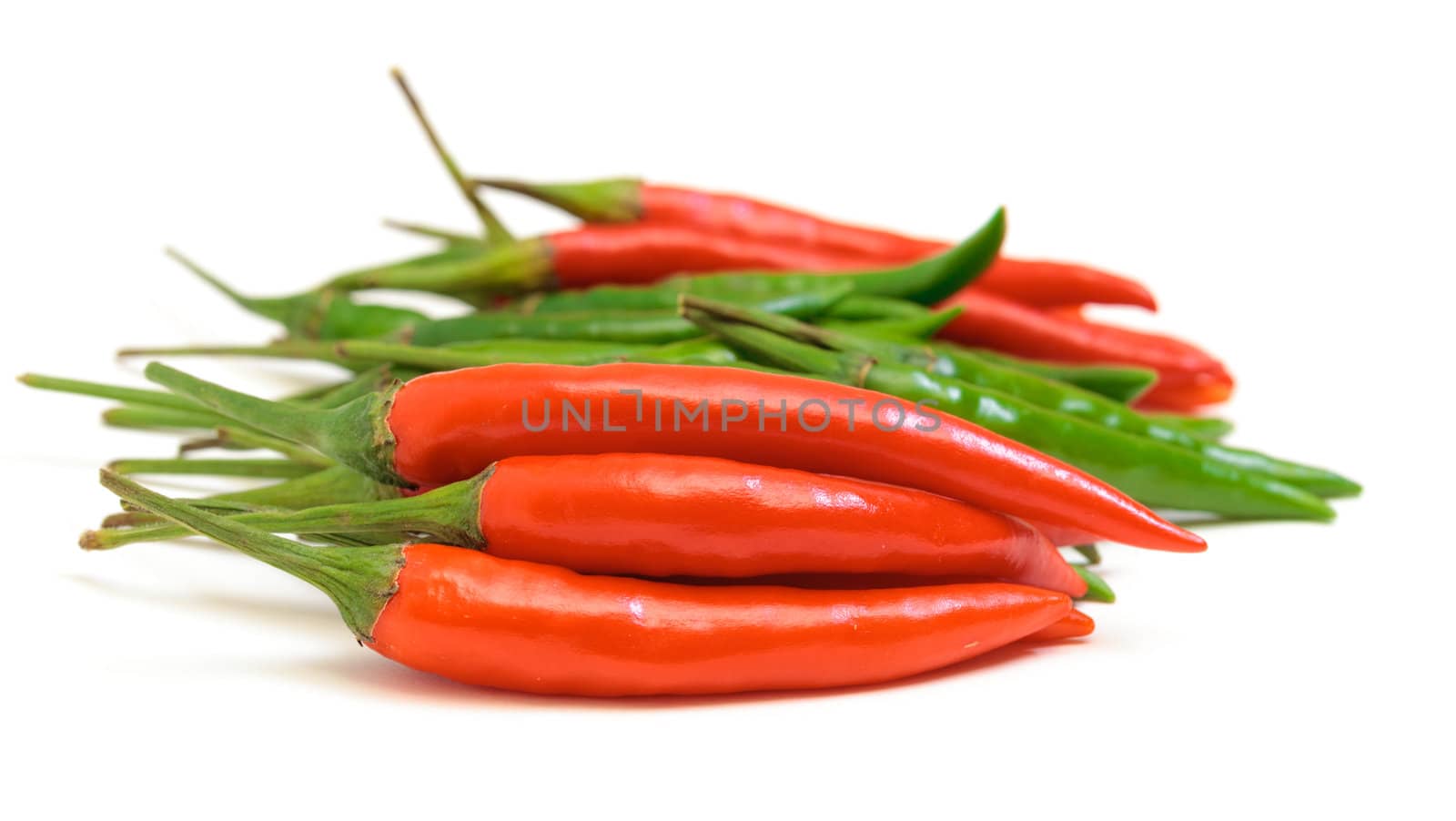 Heap Red and Green Chilli Hot Peppers on white background