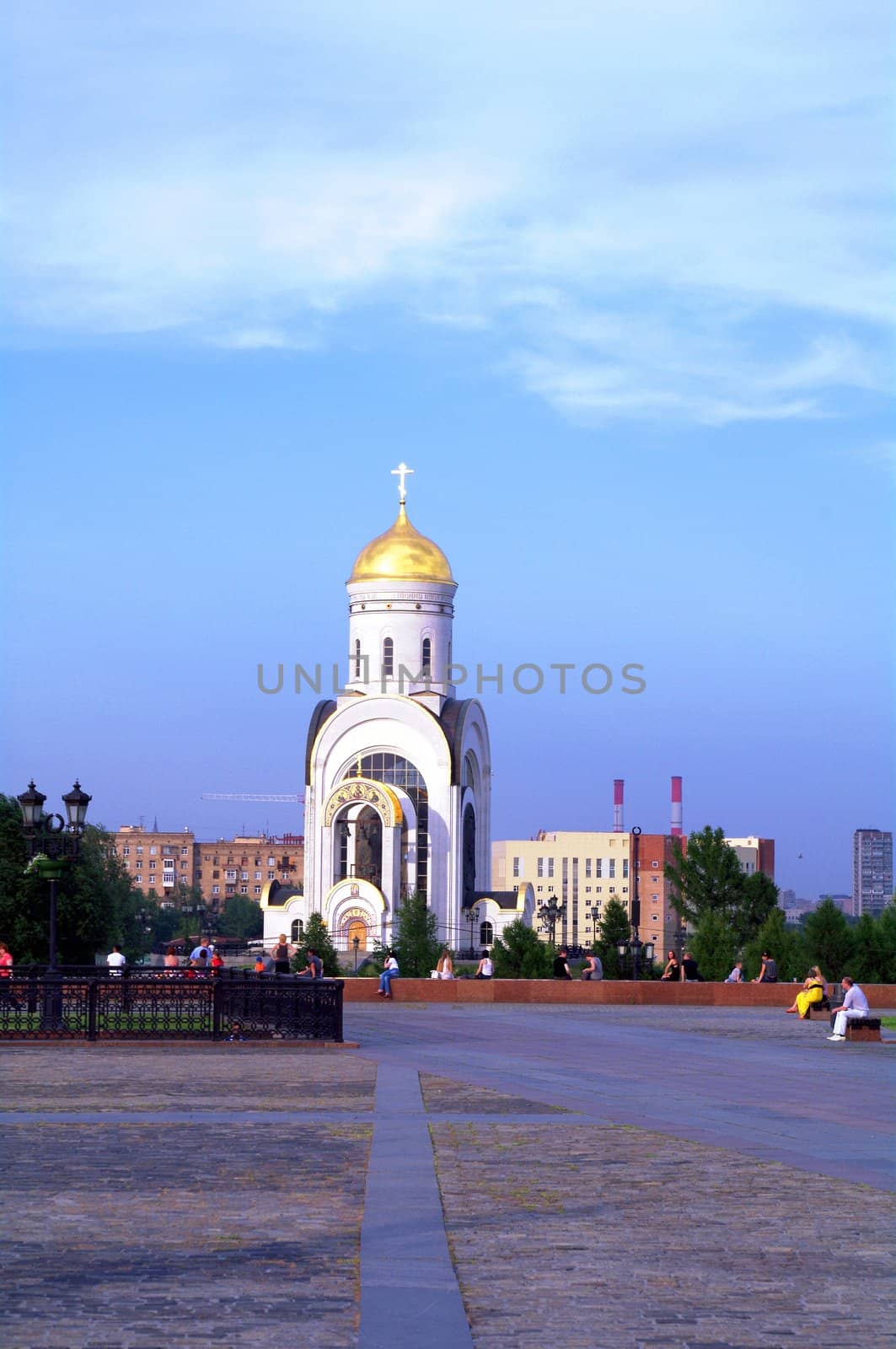 Moscow, Russia - June 26, 2010: Summer day. Peoples walk near the St. Georgy (victorious) cathedral on June 26, 2010 at victory park in Moscow, Russia by Stoyanov