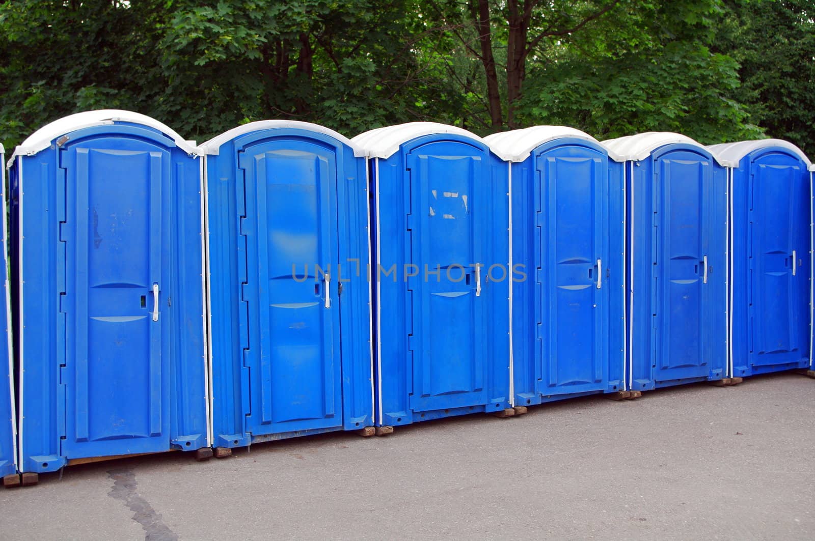 Row of blue public toilets in Moscow park by Stoyanov