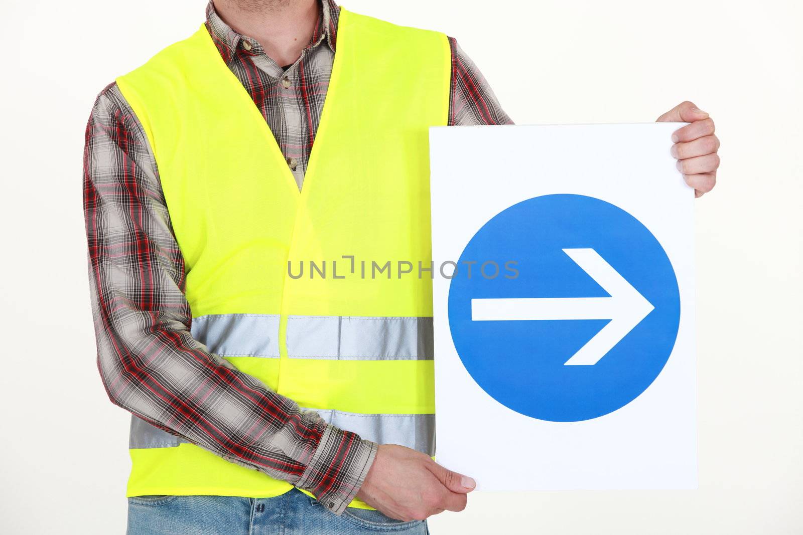 Man holding road sign by phovoir