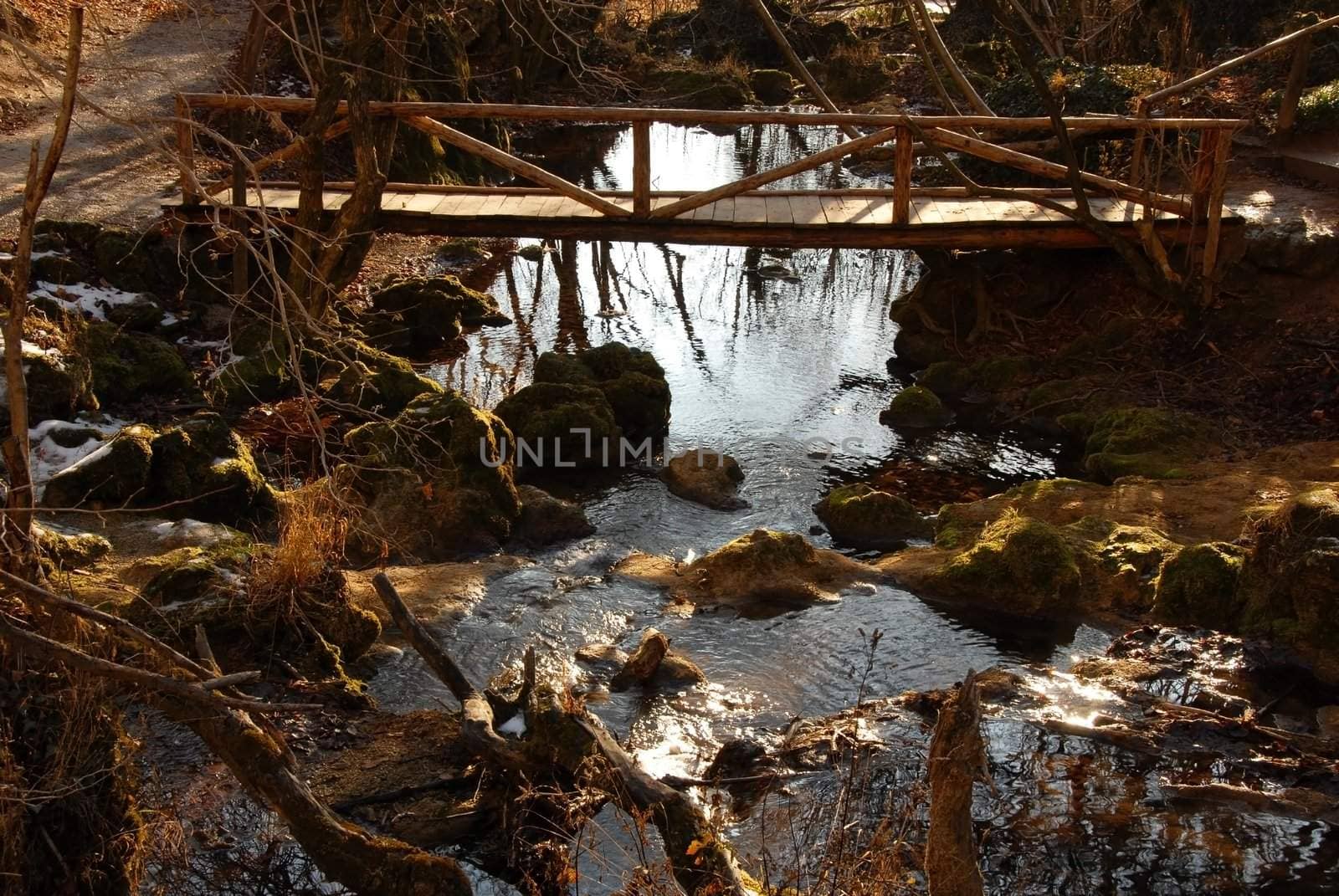 Stream and wooden bridge by simply