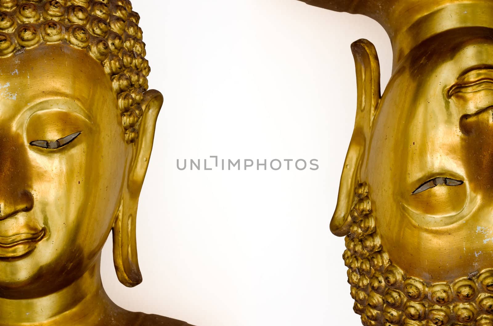 Two half face of gold buddha image isolated on white background