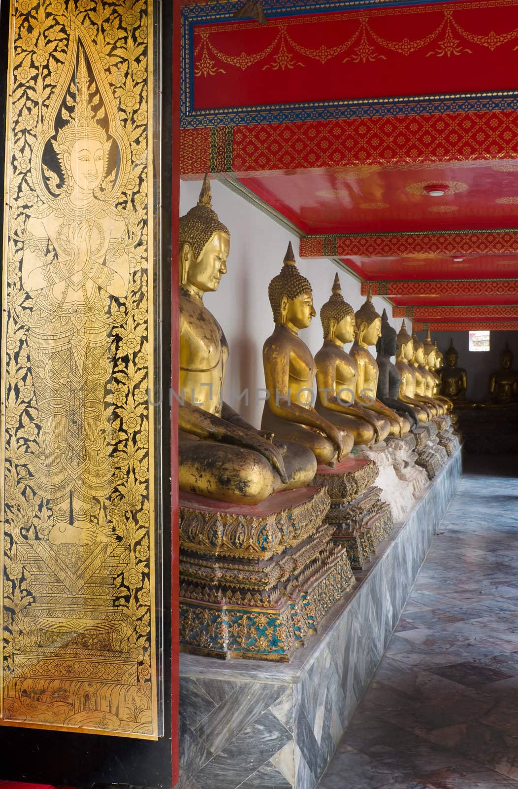 Gold thai art paint on wood door and Golden buddha image