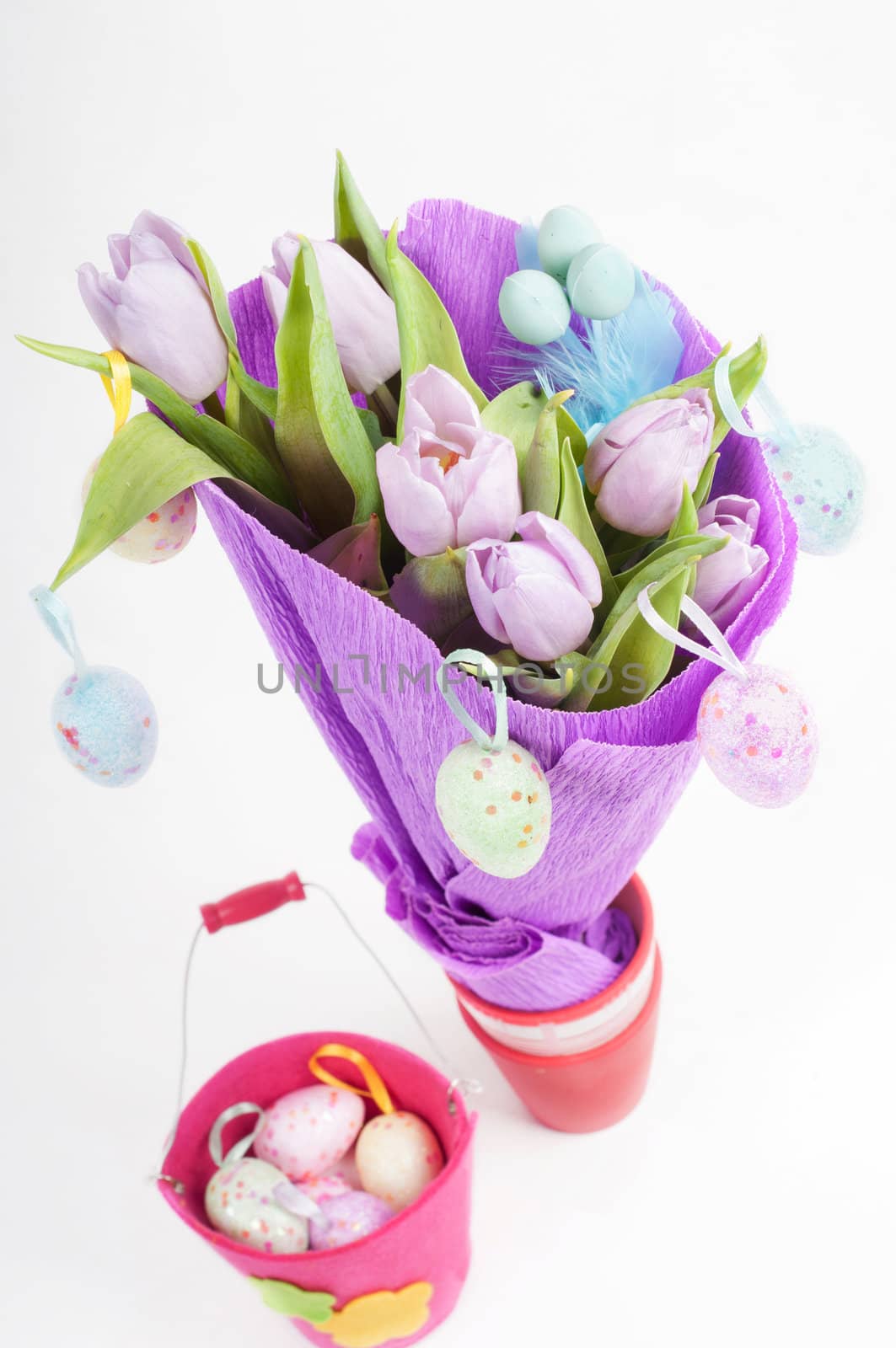 Easter eggs with bucket and tulips top view