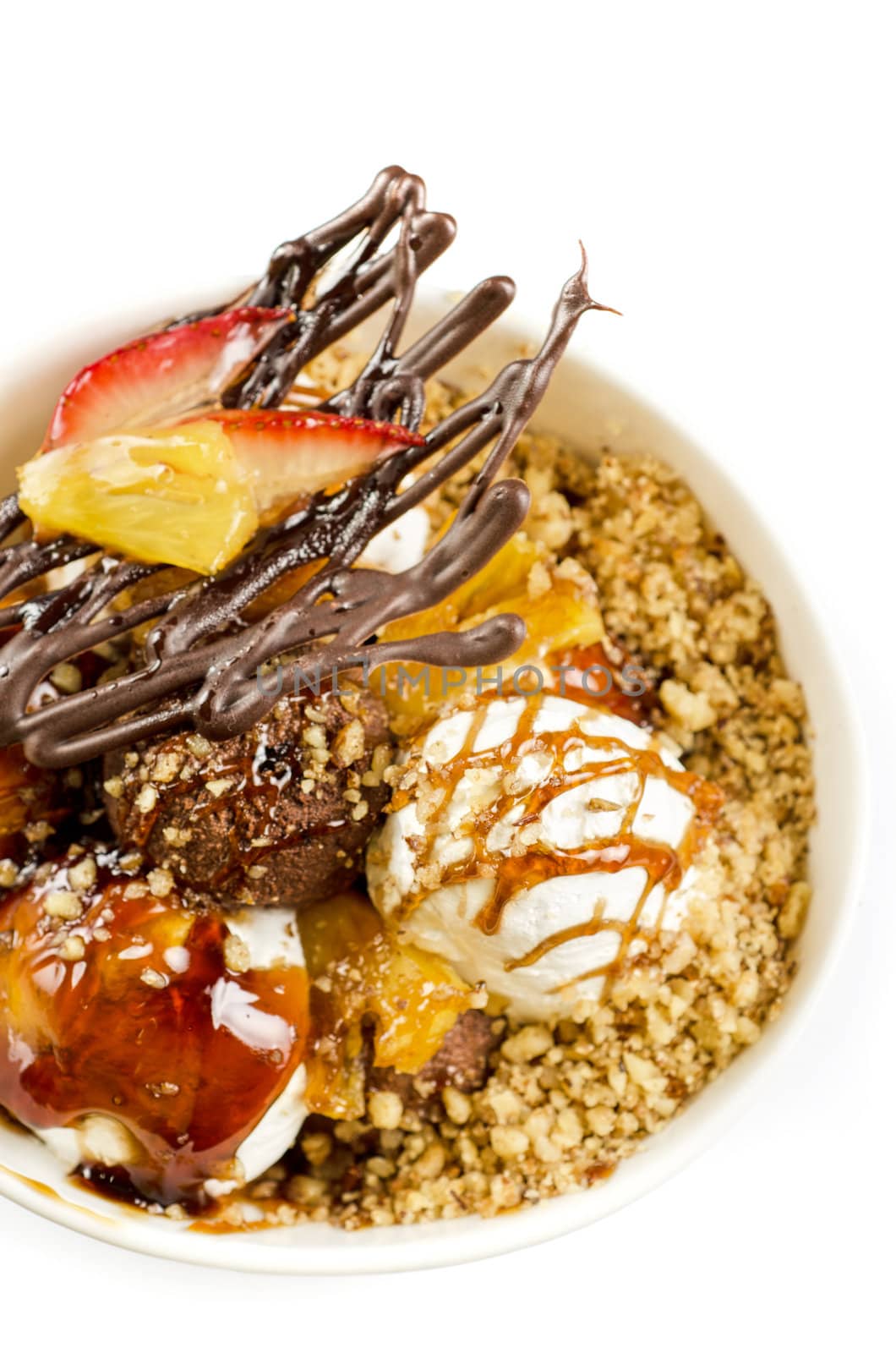 ice cream with chocolate, nuts and caramel close up on a white
